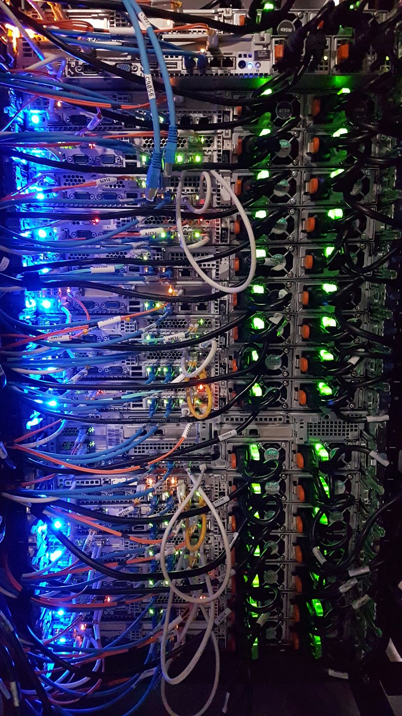 Rack de servidores con muchos cables de colores y luces brillantes.